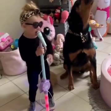 Girl and Dog Make a Great Singing Duo: Adorable Performance!