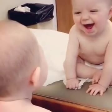first baby's reaction to the reflection in the mirror