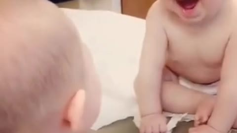 first baby's reaction to the reflection in the mirror