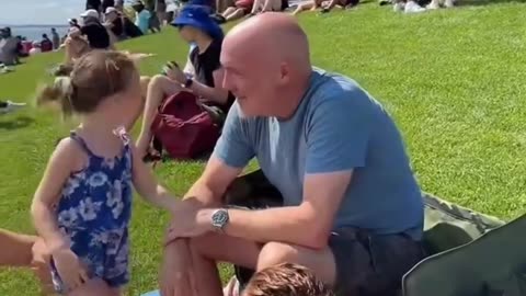 The mob is targeting a little girl and her family. Scaring the young child.