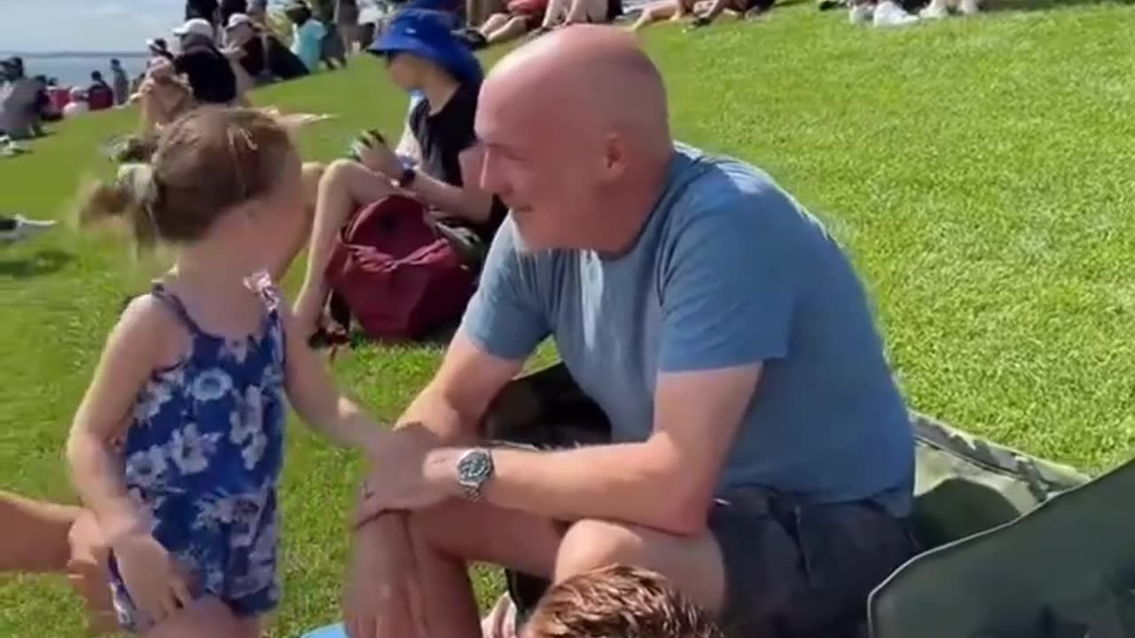 The mob is targeting a little girl and her family. Scaring the young child.