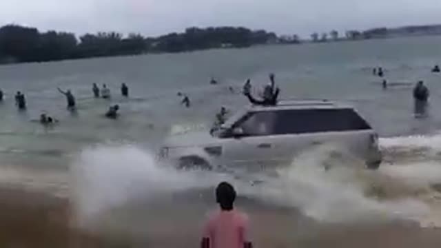 Rover left semi-submerged in the water after the driver was showboating along the shoreline