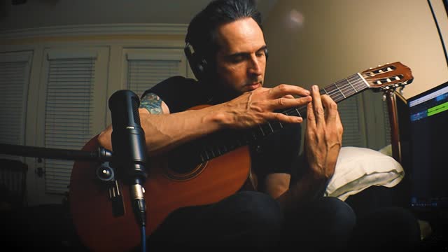 Instrumental in Em, tapping on a nylon string/ classical guitar
