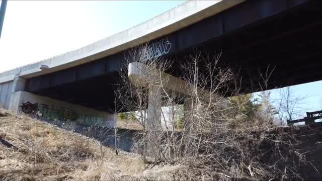 Flying near a bridge, under a bridge.