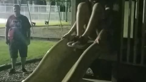 Guy goes down yellow slide skateboard