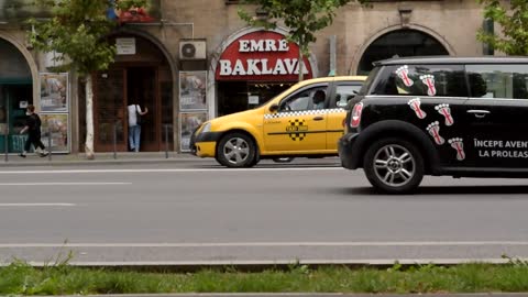 cars passing in main street bakery shop