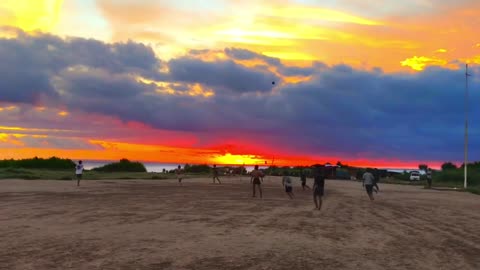 Children playing football under the sunset glow 2