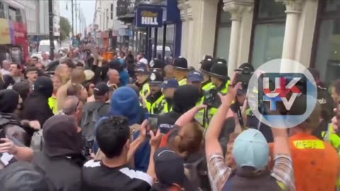 This is really vile. A few men are ring fenced by the police as an entire mob call