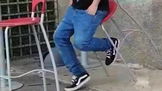 Sleeping man falls into red chair