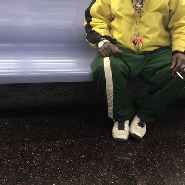 Man in yellow jacket and pink red fur hat