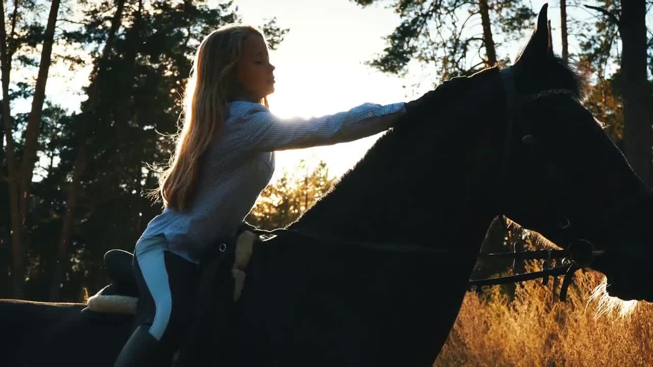 beautiful girl riding on a horse hugging her and stroking