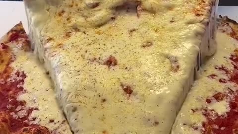Super cheesy giant pizza slice 🍕