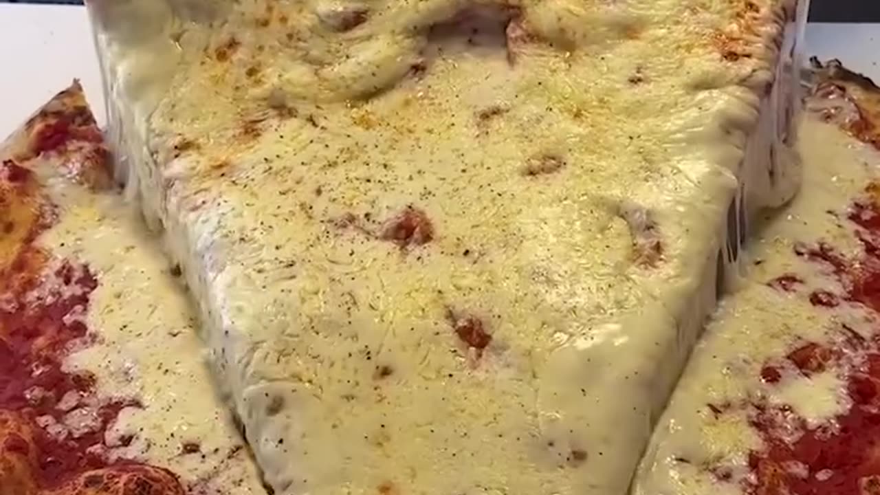 Super cheesy giant pizza slice 🍕