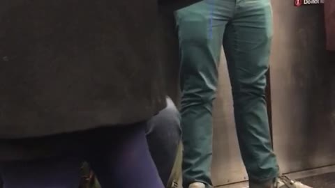 Bearded guy knits blue yarn in subway