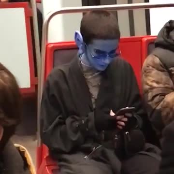 Guy glasses subway blue paint alien long ears