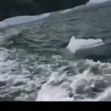 A piece of ice breaking from underwater creating a massive tsunami.😱-