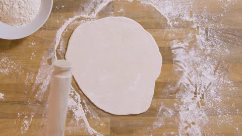 Top View Male Using Rolling Pin on Dough