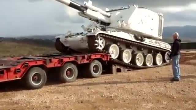 White Tank Falls off Flatbed Trailer