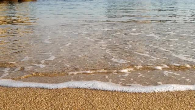 With calm waves on the beach