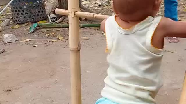 Baby learning to walk with assistive device