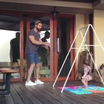 baby doing exercise together with his father