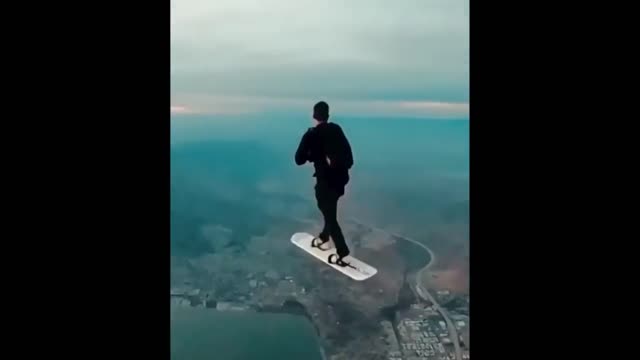 A Man Demonstrating a Sky Surfing Caught on Cam.