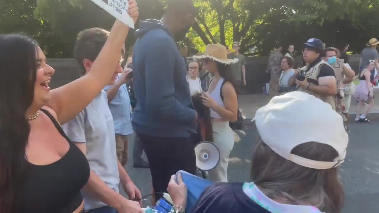 Pro-abortion protester yells misogynistic insults at woman holding a “forceps off their bodies”