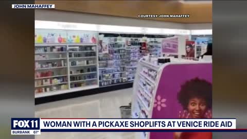 A shocking video shows a woman armed with a pickaxe shoplifting at a Rite Aid store in Los Angeles