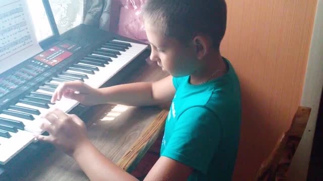 My son is playing piano