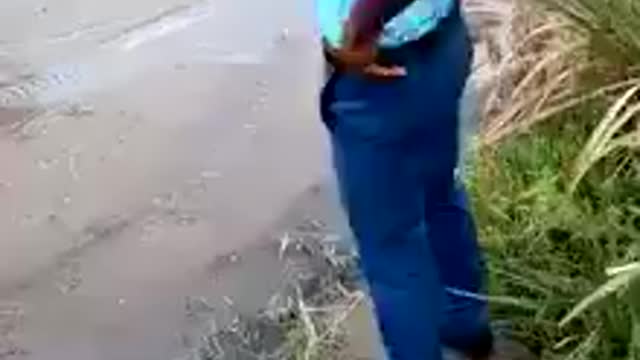 Man walking with is hand when crossing a river