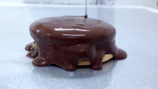 Smooth Silky Chocolate being Poured over a Cookie