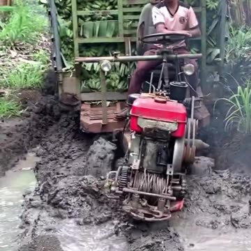 Tractor doing its work on a marshy groind