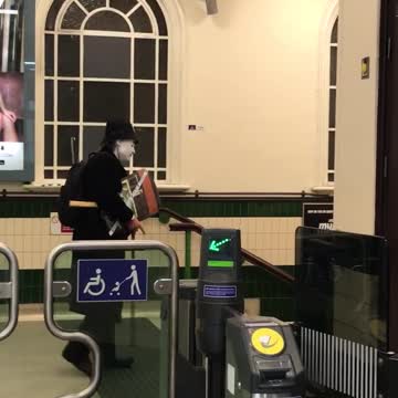 Person carrying stuff with mask and hat in subway station