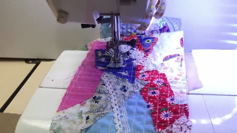 Creating new fabric by sewing fabric scraps together.