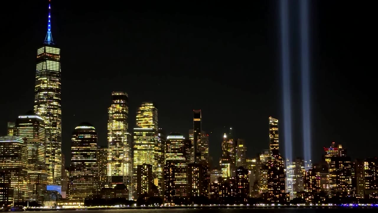 Twin blue beams mark 9/11 against New York's night sky