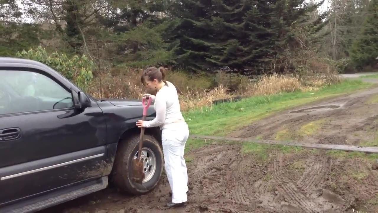 Lady's Chevrolet Suburban stuck in mud