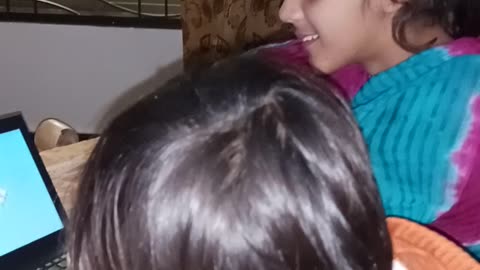 Hassan & Aysha watching cartoon at home