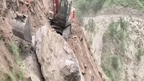 What happens when an Excavator hoists a rock 10 ti