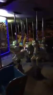 Charlies and his dad sitting on a wooden horse in the park