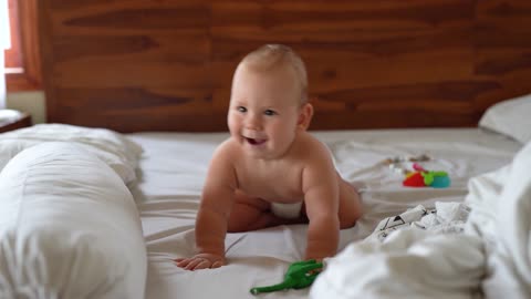 A Happy and Funny Baby on Bed