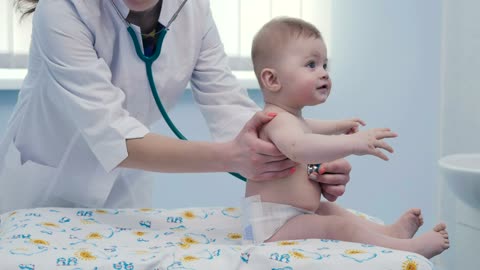 female-doctor-listening-to-a-baby-with-a-stethoscope