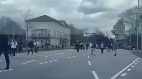 Germany, Russians in the car have their flag on the dashboard and bump into a pro-Ukrainian demo