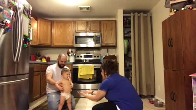 Toddler Photobombs Baby's First Steps