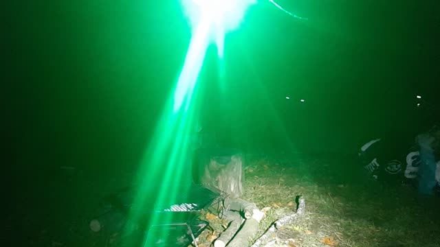 Position test before filming making a campfire in the portable firepit under a tarp