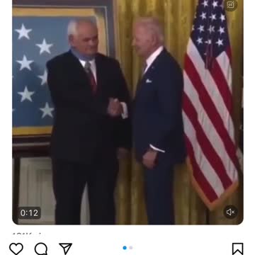 Biden puts the medal on backwards