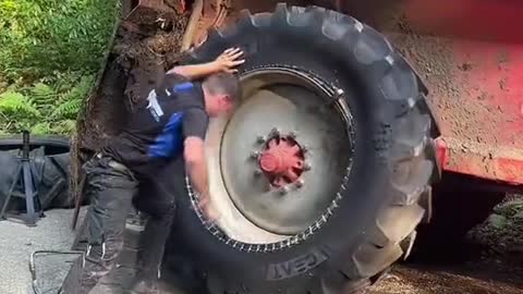 The repairman installs the tires of a large truck.