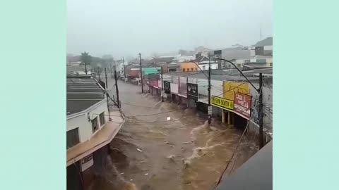 Flood drags car backwards onto some street in Brazil