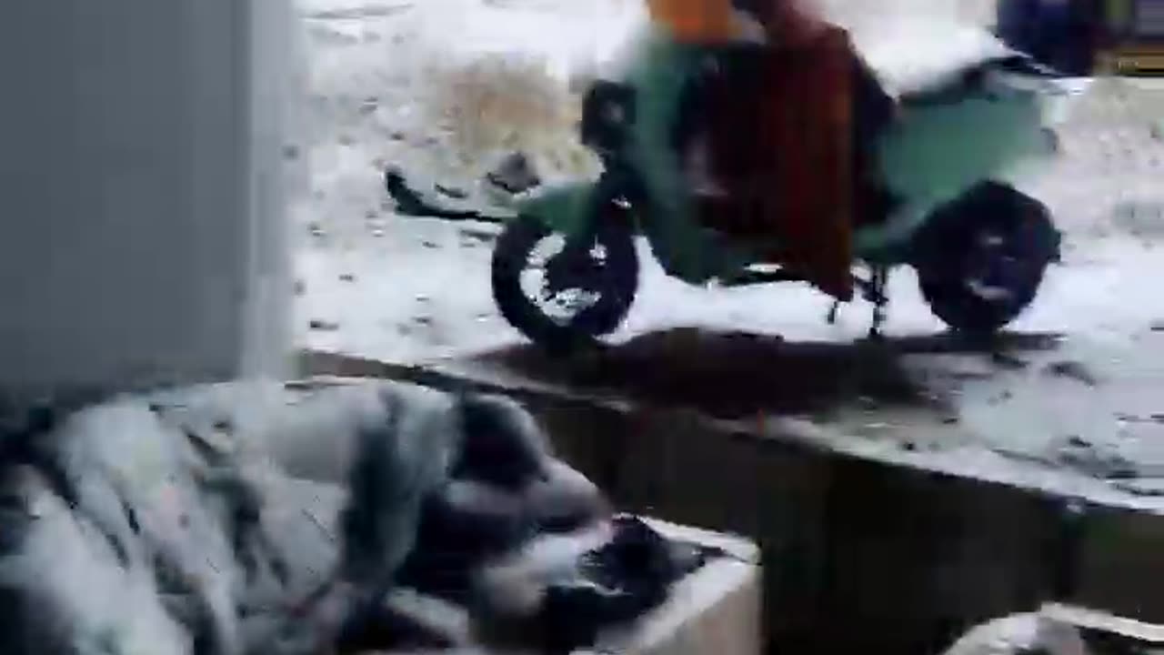 Outside in snowy Beijing, there is a homeless man lying under a bridge hole