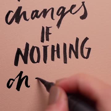 A Person Writing the Word Changes on a Paper