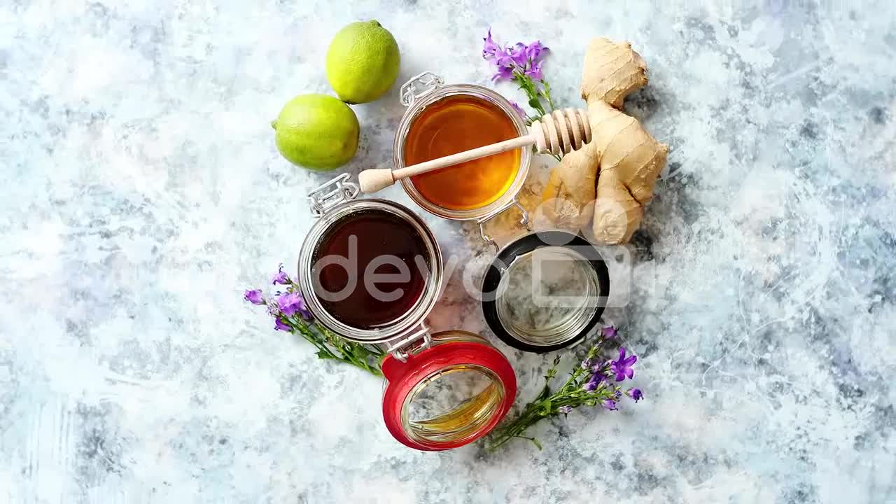 Healthy food table with different kinds of honey fresh ginger and lime